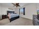 Spacious bedroom with ceiling fan, large bed and dresser at 8967 Indigo Trail Loop, Riverview, FL 33578