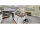 Kitchen island with granite countertop and sink overlooks living room at 8967 Indigo Trail Loop, Riverview, FL 33578