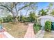 Landscaped backyard with fire pit and shed at 911 16Th Nw Ave, Largo, FL 33770