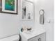 Clean bathroom with white vanity, mirror, and towel rack at 911 16Th Nw Ave, Largo, FL 33770