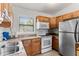 Clean kitchen with wood cabinets and tile backsplash at 911 16Th Nw Ave, Largo, FL 33770