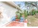 Cozy patio with two blue chairs and brick border at 911 16Th Nw Ave, Largo, FL 33770