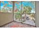 Screened balcony overlooking trees and parking at 9715 Taylor Rose Ln # 9715, Seminole, FL 33777