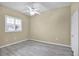 Spacious bedroom with wood-look flooring and ceiling fan at 9715 Taylor Rose Ln # 9715, Seminole, FL 33777