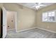 Bedroom with wood-look floors, window with blinds, and door to hallway at 9715 Taylor Rose Ln # 9715, Seminole, FL 33777