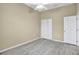 Bedroom with wood-looking floor, ceiling fan and double door closet at 9715 Taylor Rose Ln # 9715, Seminole, FL 33777