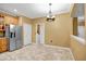 Tile floor dining area with chandelier and kitchen access at 9715 Taylor Rose Ln # 9715, Seminole, FL 33777