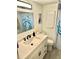 Bathroom has white vanity, updated fixtures, and fish shower curtain at 9790 66Th N St # 194, Pinellas Park, FL 33782