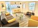 Spacious living room with grey sofa, yellow accents, and glass coffee table at 9790 66Th N St # 194, Pinellas Park, FL 33782