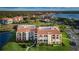 Condo building with surrounding landscape and water at 102 Mariner Dr, Tarpon Springs, FL 34689