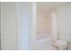 Clean bathroom with a tub, toilet, and linen closet at 102 Mariner Dr, Tarpon Springs, FL 34689