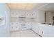 White kitchen with built-in appliances and ample counter space at 102 Mariner Dr, Tarpon Springs, FL 34689