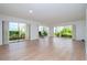 Bright living room with wood floors and sliding glass doors at 102 Mariner Dr, Tarpon Springs, FL 34689