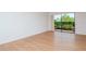 Living room with wood-look floors and sliding glass doors at 102 Mariner Dr, Tarpon Springs, FL 34689