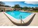 Community pool with patio furniture and grill at 102 Mariner Dr, Tarpon Springs, FL 34689