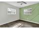 Bright bedroom with wood-look floors and an accent wall at 11320 114Th Ave, Largo, FL 33778