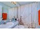 Clean bathroom with a shower/tub combo and a lighthouse-themed shower curtain at 11511 Lounds Ct, New Port Richey, FL 34654