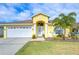 Bright yellow house with white garage door and landscaping at 11511 Lounds Ct, New Port Richey, FL 34654