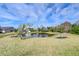 Scenic backyard view of a pond with lush landscaping at 11511 Lounds Ct, New Port Richey, FL 34654