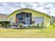 Large screened patio with seating, string lights, and landscaping at 11511 Lounds Ct, New Port Richey, FL 34654