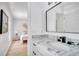 Elegant bathroom with a marble countertop and a sleek black faucet, with a view to the bright bedroom beyond at 11624 Monette Rd, Riverview, FL 33569