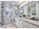 Modern bathroom features a marble shower, double vanity with stone countertop, and contemporary fixtures at 11624 Monette Rd, Riverview, FL 33569