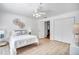 Well-lit bedroom with light wood floors, a ceiling fan, and white walls for a clean and simple design at 11624 Monette Rd, Riverview, FL 33569