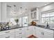 Bright and airy kitchen with stainless steel sink, pendant lighting, and access to the outdoor space at 11624 Monette Rd, Riverview, FL 33569