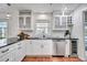 Bright kitchen with stainless steel appliances, wine cooler, white cabinets, and brick-style flooring at 11624 Monette Rd, Riverview, FL 33569