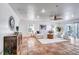 Bright living room featuring a neutral sectional sofa, tile flooring, and an abundance of natural light at 11624 Monette Rd, Riverview, FL 33569