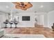 Spacious living room featuring tile floors, a fan, and a view into the modern bar and kitchen area at 11624 Monette Rd, Riverview, FL 33569