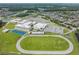 Aerial view of school campus, athletic fields and surrounding neighborhood at 12292 Lyon Pine Ln, Odessa, FL 33556