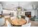 Open concept dining area with wood table and chairs, adjacent to kitchen at 12292 Lyon Pine Ln, Odessa, FL 33556