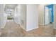 Bright hallway with wood-look tile flooring and built-in shelving at 12292 Lyon Pine Ln, Odessa, FL 33556