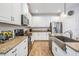 Modern kitchen with granite countertops, stainless steel appliances, and farmhouse sink at 12292 Lyon Pine Ln, Odessa, FL 33556