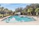 Relaxing community pool with lounge chairs and a cabana at 12292 Lyon Pine Ln, Odessa, FL 33556