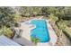 Community pool with plenty of lounge chairs at 12292 Lyon Pine Ln, Odessa, FL 33556