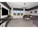 Comfortable living room featuring plush gray sectional, accent tables and decorative light fixture at 12682 Glenn Creek Dr, Riverview, FL 33569