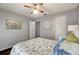 Bright bedroom with a ceiling fan and nautical bedding at 1400 Gandy N Blvd # 1407, St Petersburg, FL 33702