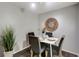 Dining area with white table and gray chairs, and decorative wall art at 1400 Gandy N Blvd # 1407, St Petersburg, FL 33702