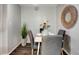 Dining area with white table, gray chairs and decorative centerpiece at 1400 Gandy N Blvd # 1407, St Petersburg, FL 33702