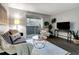 Living room with gray sofa, wooden coffee table, and dark laminate floors at 1400 Gandy N Blvd # 1407, St Petersburg, FL 33702