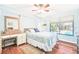 Bedroom with a queen bed, pool view, and built-in dresser at 14031 Shady Shores Dr, Tampa, FL 33613