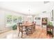 Formal dining room with hardwood floors, large windows, and a wooden table at 14031 Shady Shores Dr, Tampa, FL 33613