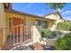 Bright yellow house with orange door and a charming gated entryway at 14031 Shady Shores Dr, Tampa, FL 33613