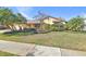 Single-story house with attached garage and manicured lawn at 14031 Shady Shores Dr, Tampa, FL 33613