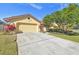 Single-story house with attached garage and manicured lawn at 14031 Shady Shores Dr, Tampa, FL 33613