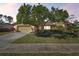 Single-story house with a well-manicured lawn and attached garage at 14031 Shady Shores Dr, Tampa, FL 33613