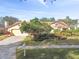 Yellow stucco house with mature landscaping, a driveway, and a mailbox at 14031 Shady Shores Dr, Tampa, FL 33613