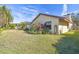 Back exterior view of a single story house with manicured lawn at 14031 Shady Shores Dr, Tampa, FL 33613